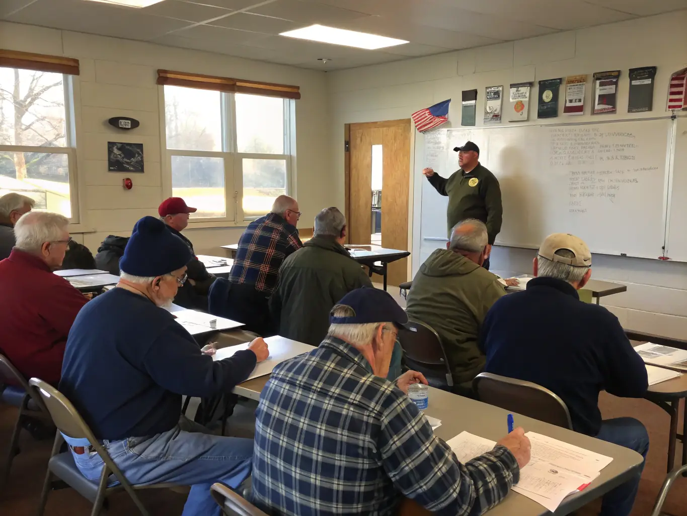 A classroom setting with a veteran sharing their experiences with a group of students. The veteran is wearing their uniform, and the students are attentively listening and taking notes.